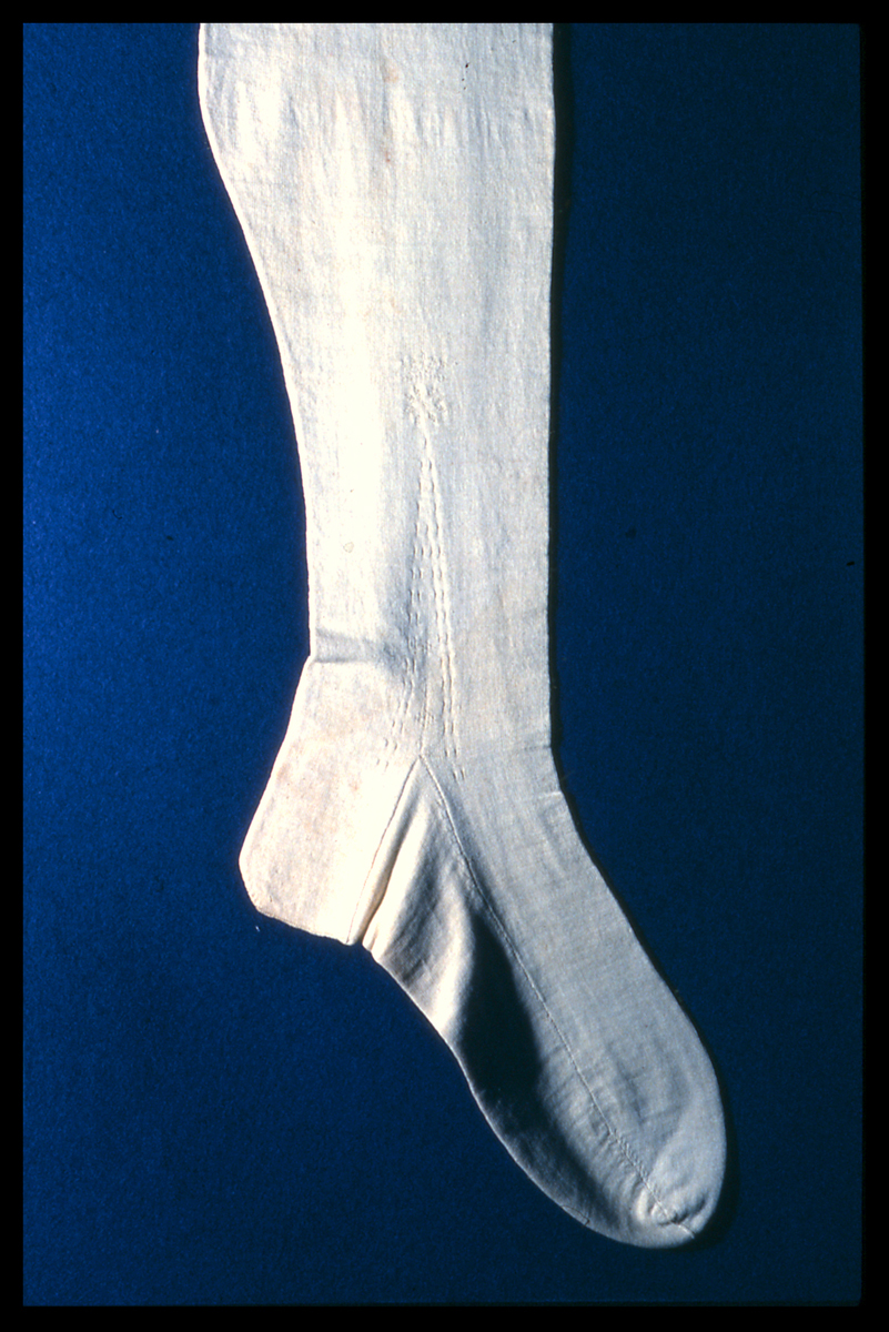 An early cotton stocking. The attached label from 1851 records that the stocking was made in 1790 with cotton spun by Richard Arkwright. Nottingham City Museums